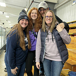 Family picture at a hockey game.